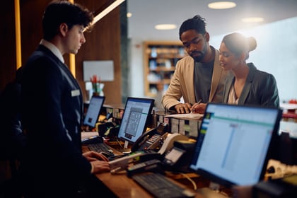 multiracial-couple-signing-documents-while-checkin-2024-03-06-18-24-37-utc
