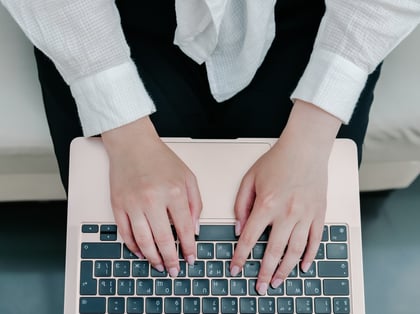 woman-holding-a-laptop-in-her-hands-and-typing-on-2023-11-27-05-23-10-utc